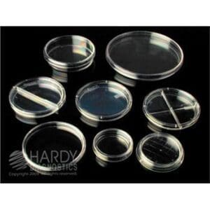 Various sizes of clear plastic petri dishes arranged on a black background.